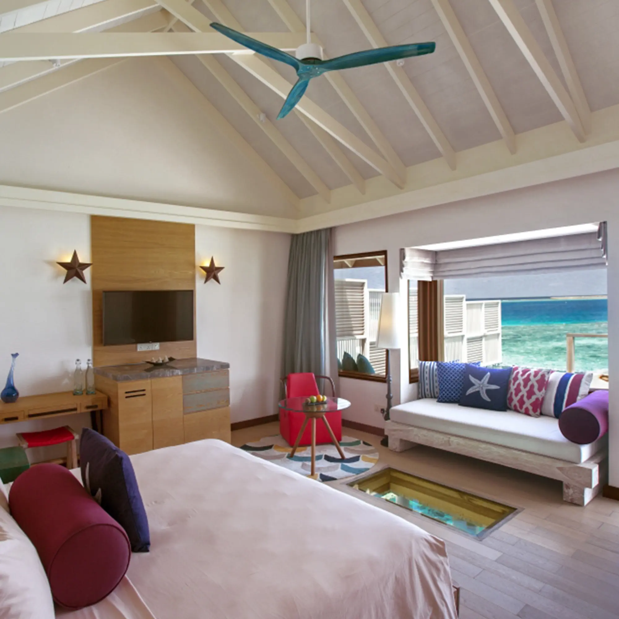 Luxuriöse Wasservilla mit direktem Zugang zum klaren türkisfarbenen Meer, ausgestattet mit modernen Möbeln und einem traditionellen Strohdach.