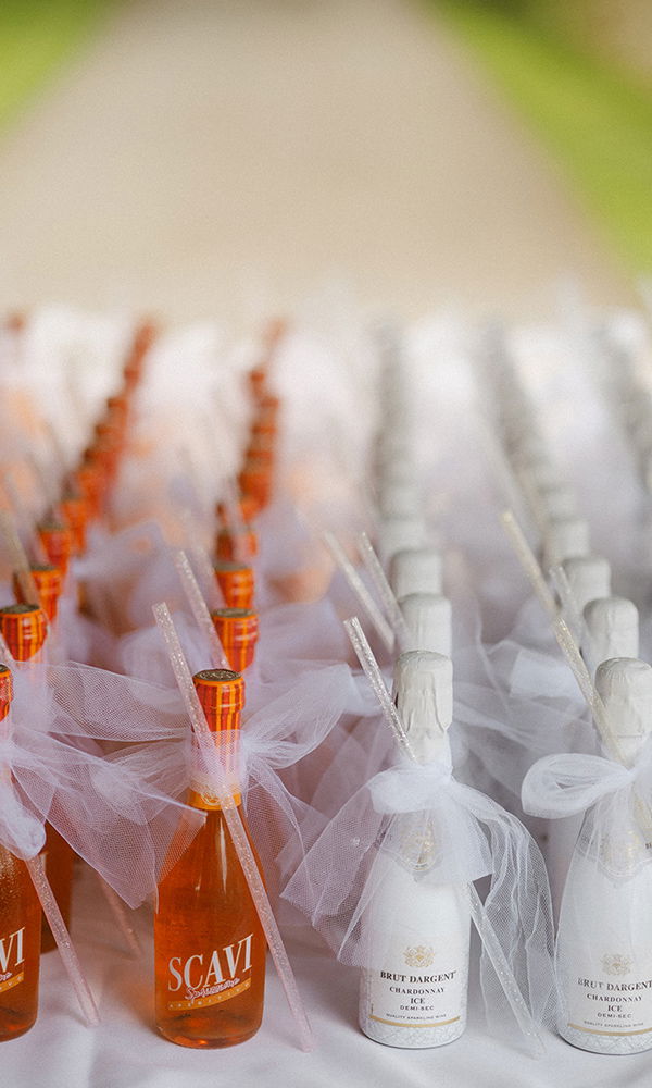 Getränkeauswahl für Hochzeitsgäste, liebevoll mit Tüllschleifen dekoriert.